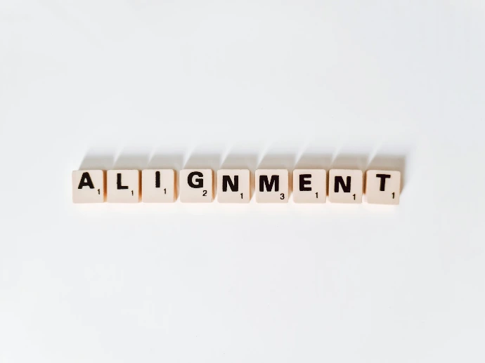 the word alignmentment spelled with scrabble letters